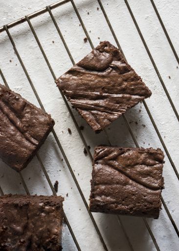 Pieces of brownies cooling on a rack.