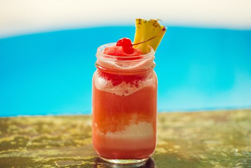 A closeup shot of a refreshing alcohol cocktail drink on a bar