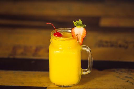 A closeup shot of a refreshing alcohol cocktail drink on a bar
