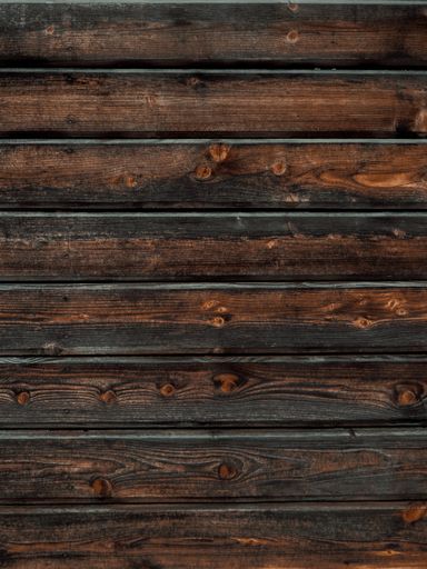 A vertical closeup of a wooden plank wall - great for backgrounds and wallpapers