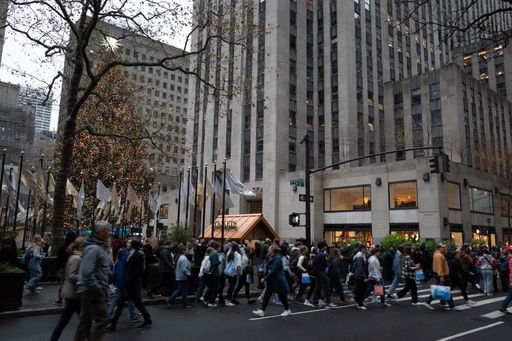 A crowd of people in Rockefeller Center at Christmas