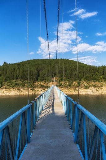 A vertical high angle shot of the suspension bridge over the Kardzhali dam, Bulgaria