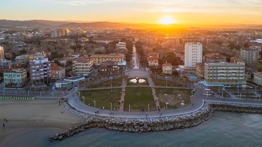 Bird's eye view of the beautiful Pesaro cityscape at Christmas time, with twinkling lights and colorful decorations to celebrate the holiday season