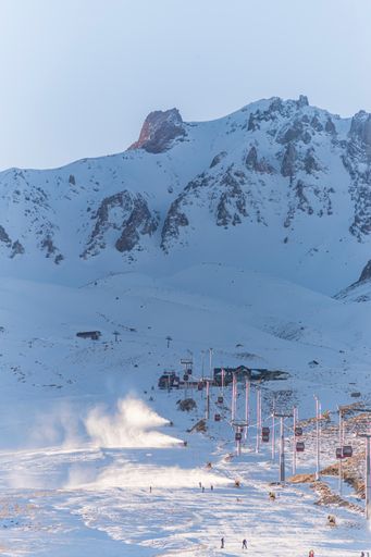 A vertical shot of snowy Erciyes mount and a ropeway