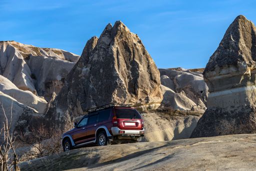 The tourists discover the beautiful Fairy Chimney formations in Cappadocia by off-road vehicles