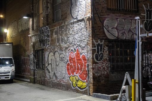 A vibrant street scene with a parked car situated in front of a building in New York, United States