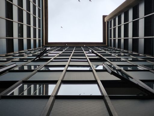 A shot of a multistory building from its ground floor