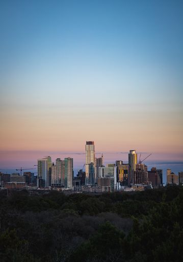 An aerial view of the beautiful skyline of Downtown Austin, Texas illuminated by the golden sunset
