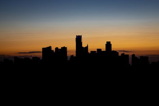 An aerial view of the beautiful skyline of Downtown Austin, Texas illuminated by the golden sunset