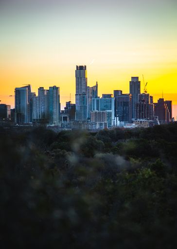 An aerial view of the beautiful skyline of Downtown Austin, Texas illuminated by the golden sunset