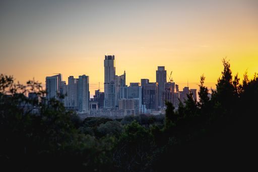 An aerial view of the beautiful skyline of Downtown Austin, Texas illuminated by the golden sunset
