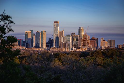 An aerial view of the beautiful skyline of Downtown Austin, Texas illuminated by the golden sunset