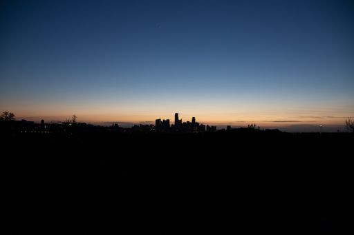 An aerial view of the beautiful skyline of Downtown Austin, Texas illuminated by the golden sunset