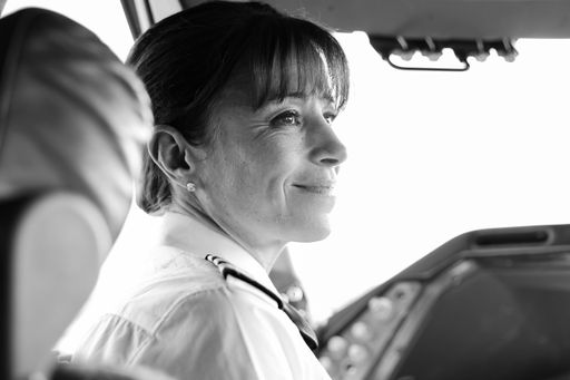 Johannesburg, South Africa - May 08 2012: British Airways Middle Aged Female Captain Pilot in an Airplane cabin