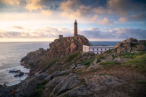 A breathtaking landscape of the Cape Vilan lighthouse on a cloudy day in Galicia, Spain.