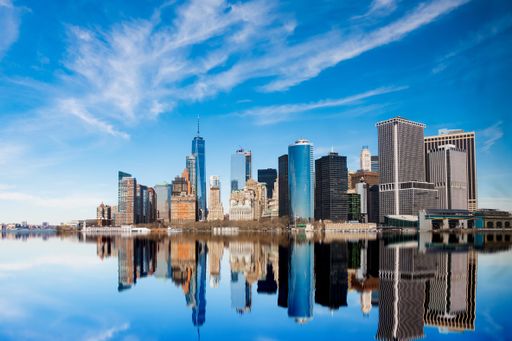 A breathtaking view of Manhattan buildings reflection in the Hudson River