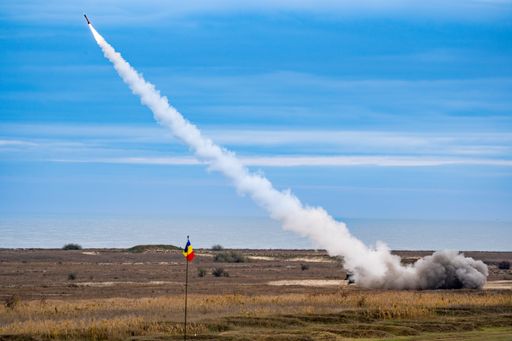 A rocket soaring in the sky, with a billowing cloud of smoke trailing behind it