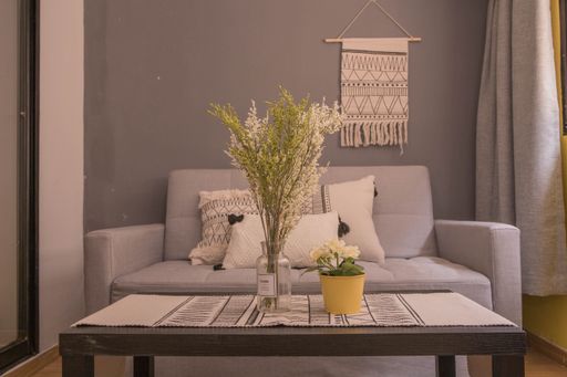 An interior design of a modern room with a sofa next to bedroom