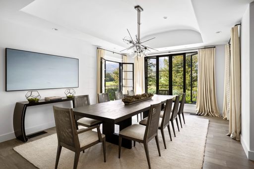 A spacious dining room with a sophisticated, classic design
