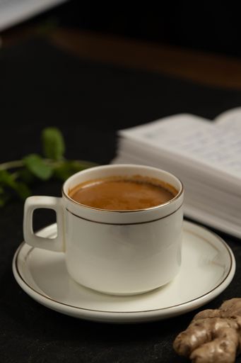 A steaming cup of cappuccino topped with foam