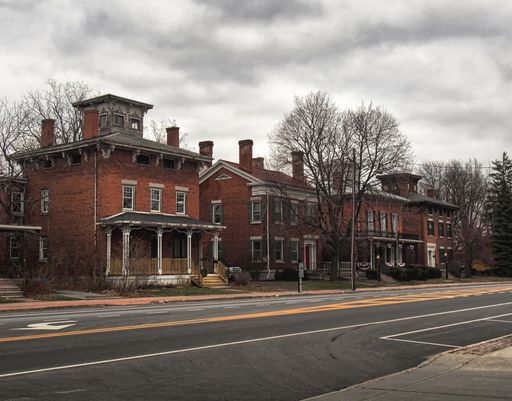 street with old fashioned Victorian Italianate style brick homes