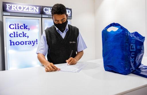 Cape Town, South Africa - December 10, 2020: Staff member checking online grocery order for express home delivery service at local Pick n Pay