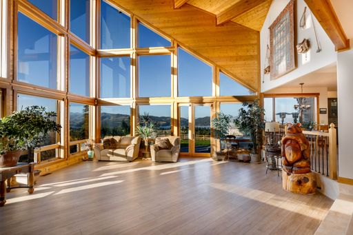 This image features a stunning interior decor with a wooden floor and furniture, creating a warm, inviting atmosphere