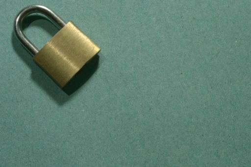 A padlock on a textured green background with space for your text
