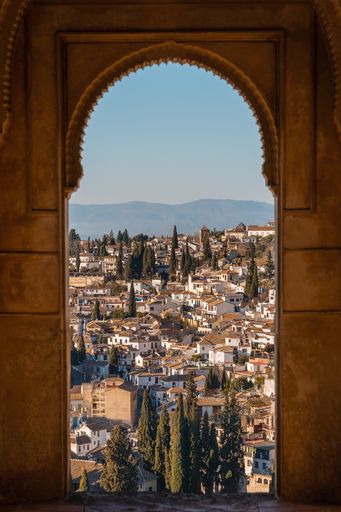 A View of the old town of Granada inside an arch of the Alhambra, Spain