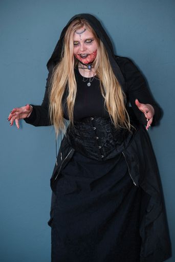 A female cosplayer in a fantasy witch costume