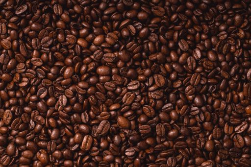 A close-up of a pile of freshly roasted coffee beans