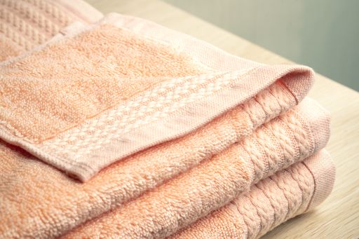 The two folded towels neatly arranged in a row on a flat surface