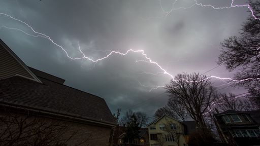 The Ohio winter lightning strike in the sky with an impeding thunderstorm in the distance