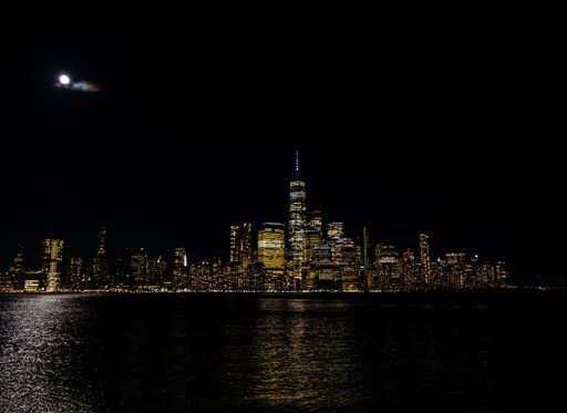 A stunning nightscape of a bustling city skyline seen from the water