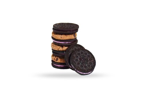 A closeup of sandwich cookies and chocolate chip cookies isolated on a white background