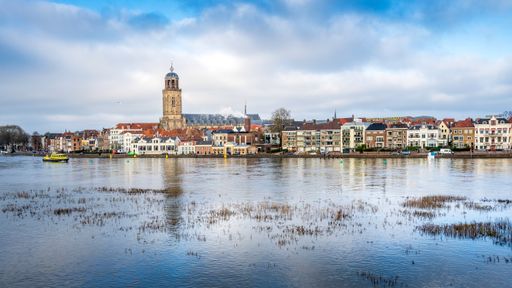 A scenic view of the town of Deventer along a river in the Netherlands