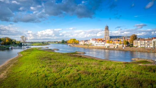 A scenic view of the town of Deventer along a river in the Netherlands