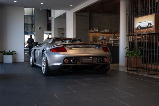 A sleek gray Porsche showcased at a salon