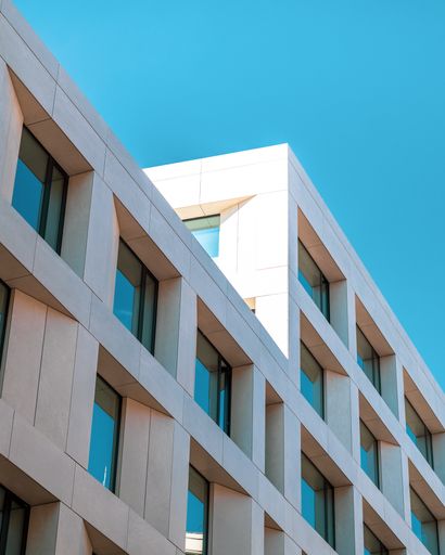 A low angle shot of a squared stone building under a blue sky