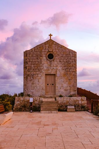A view of the St Mary Magdalene Chapel in Dingli at purple sunset, Malta