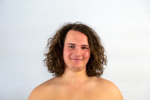 A portrait of a male with long blonde hair
