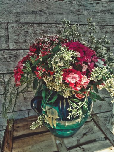 a vertical shot of beautiful colorful flowers in a pot
