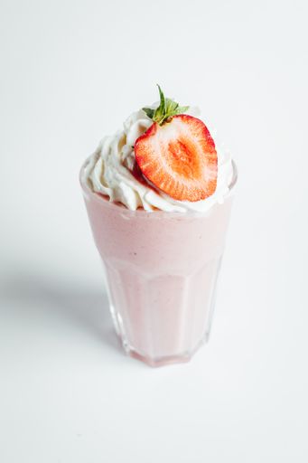 A closeup shot of a strawberry mousse on white background