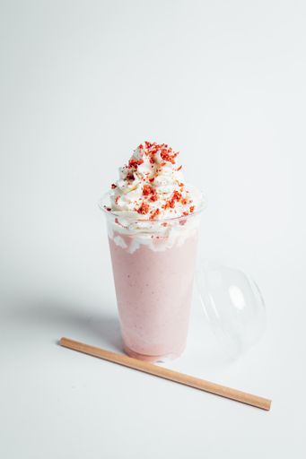 A closeup shot of a strawberry mousse on white background