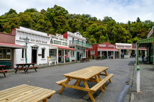 This image showcases several benches positioned along the street in front of a prominent building