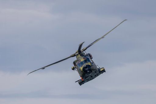 A spacious helicopter soars freely in the sky, displaying its fully extended propellers