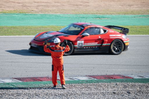 The track marshal warning of an accident, signaling with his arms to slow down