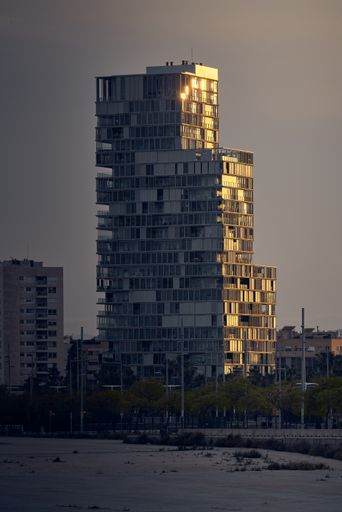 A scenic view of an old residential building in an urban area during sunset