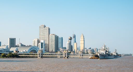 The cityscape of Wuhan with large ships moored in the harbor
