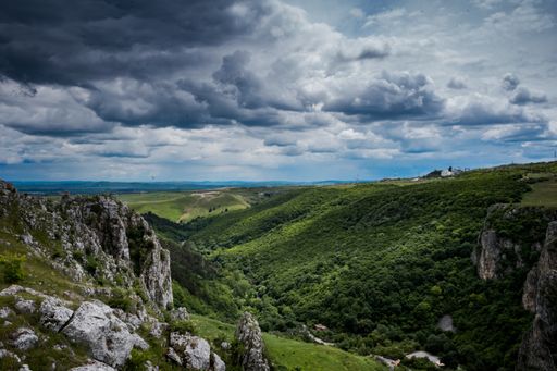 A mesmerizing view of a beautiful mountainous landscape in the cloudy sky